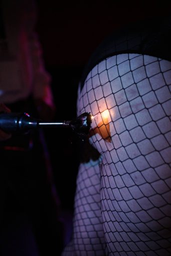 dungeon zap zap A pair of legs in fishnets getting shocked with a violet wand